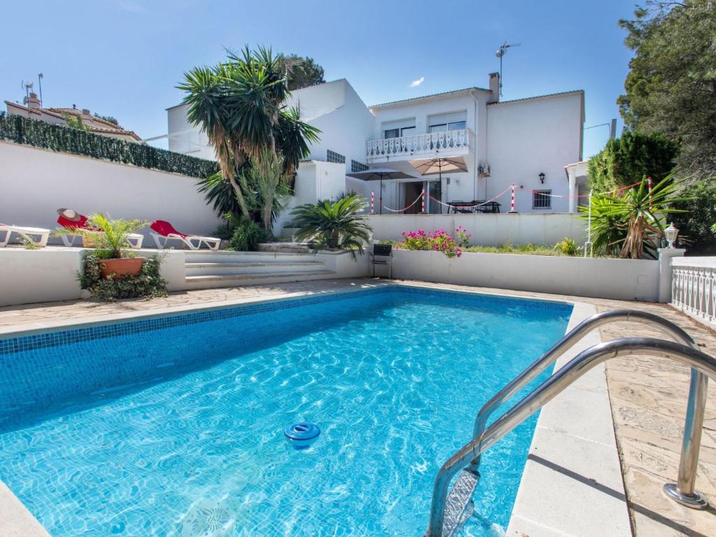 a swimming pool in the backyard of a house at Villa Marina by Interhome in L'Ametlla de Mar