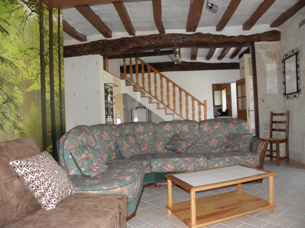 a living room with a couch and a table at Gîte Flottille de Loire in Chouzé-sur-Loire