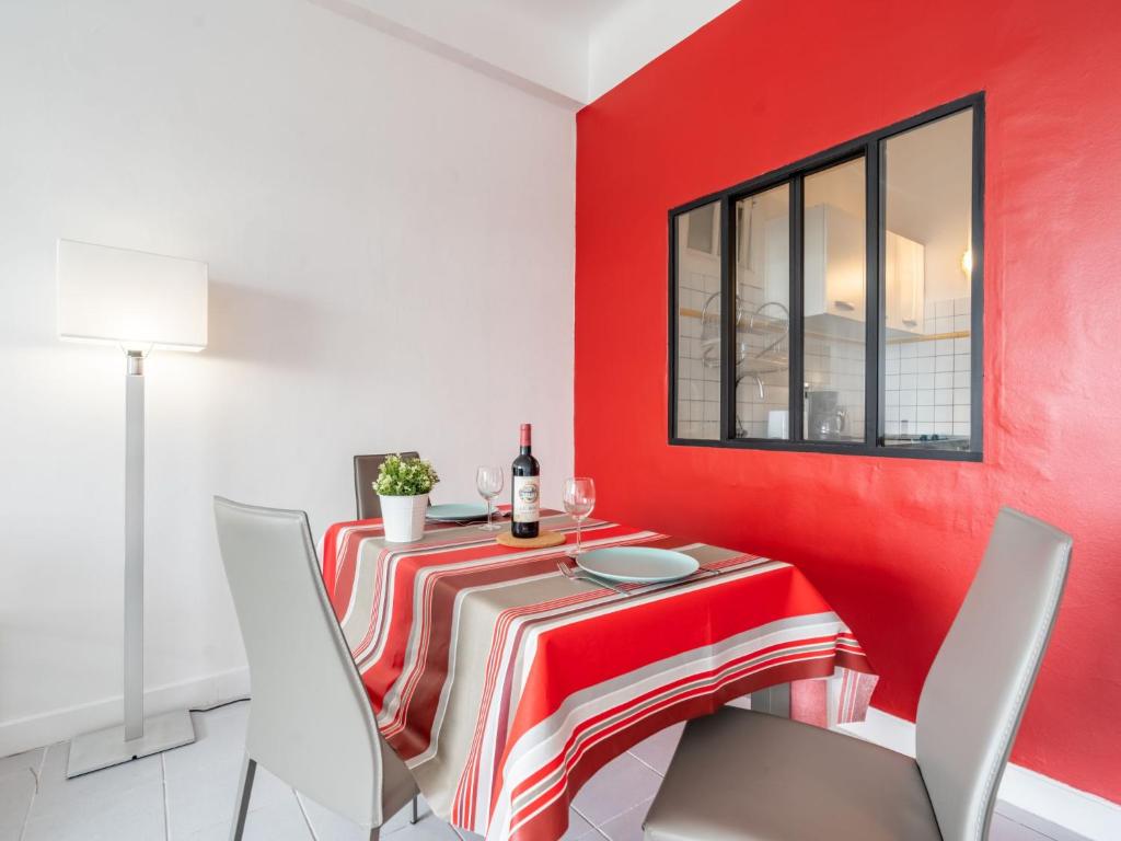a red dining room with a red and white table and chairs at Studio La Pergola-8 by Interhome in Saint-Jean-de-Luz