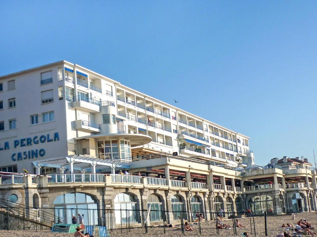 a hotel on the beach with people on the beach at Studio La Pergola-8 by Interhome in Saint-Jean-de-Luz