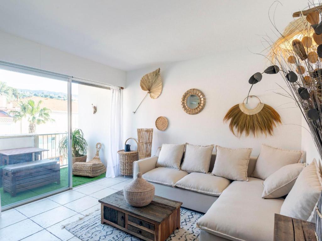 una sala de estar con un sofá y una mesa en Apartment La Méridienne-5 by Interhome, en Le Lavandou