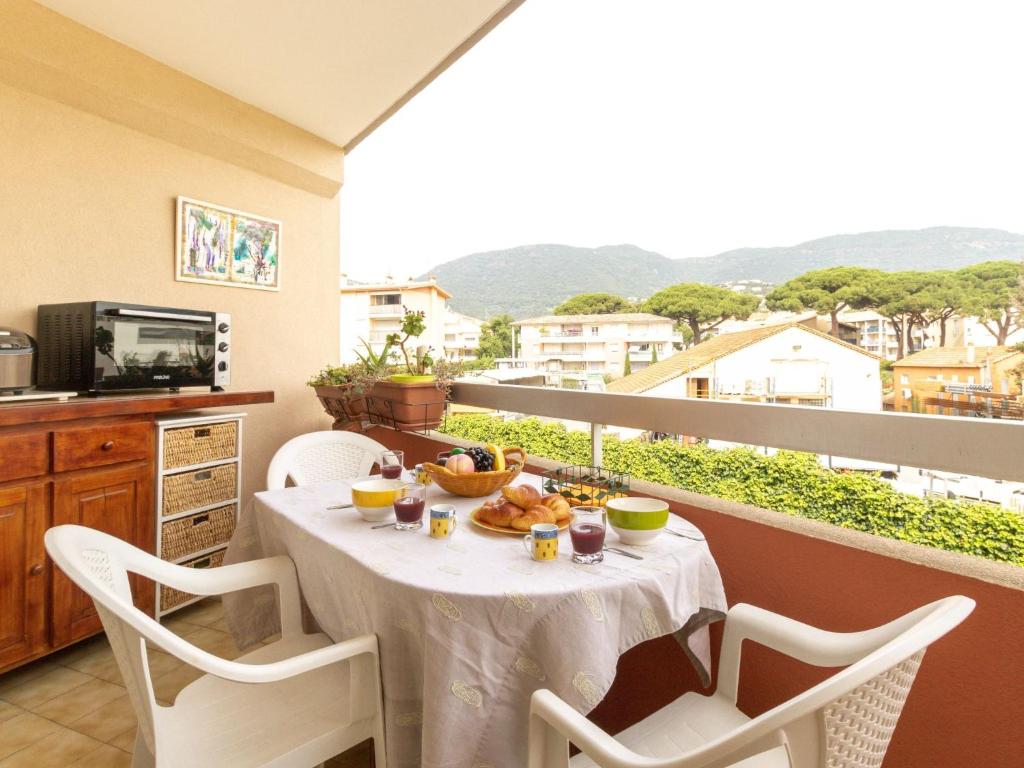 a table with food on top of a balcony at Studio Le Grand Foc-3 by Interhome in Cavalaire-sur-Mer
