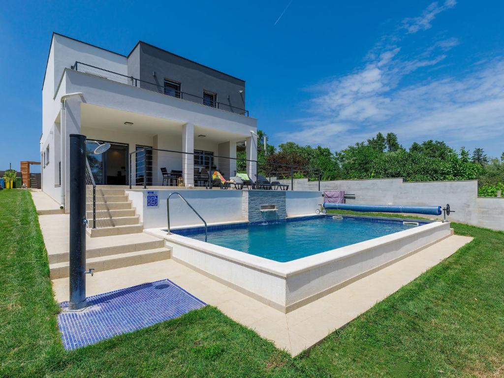 a house with a swimming pool in the yard at Villa Tara by Interhome in Medulin
