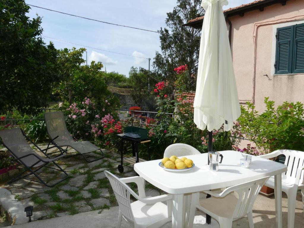 a white table and chairs with an umbrella at Holiday Home Ca'Mea by Interhome in Chiusanico