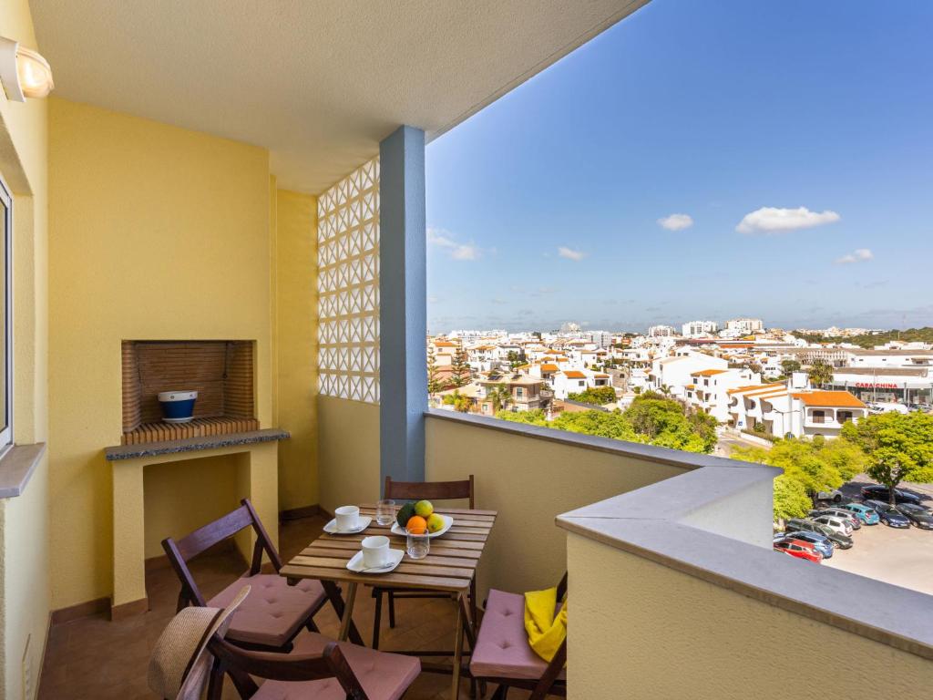 a balcony with a table and chairs and a view of a city at Apartment Capital 4 You by Interhome in Portimão