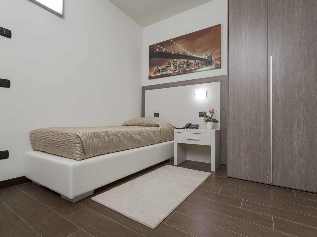 Postel nebo postele na pokoji v ubytování Ferrari Hotel