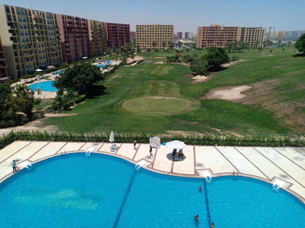an overhead view of a golf course with a large pool at chalet 9 porto golf marina Egyptian only in El Alamein