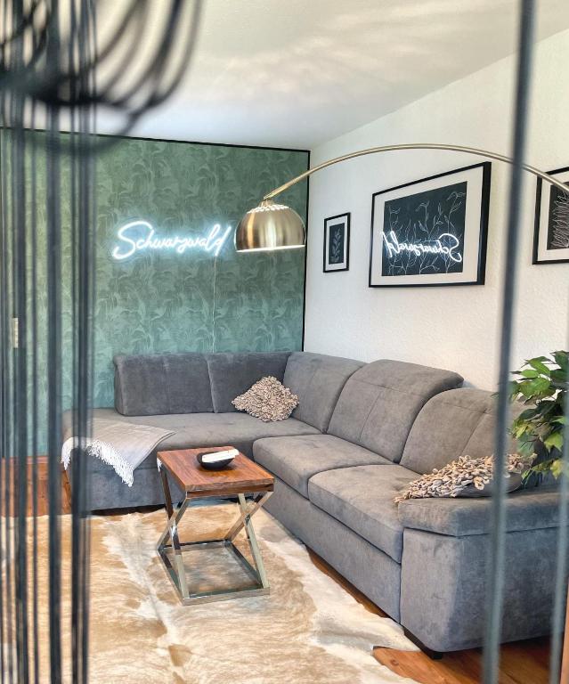 a living room with a couch and a table at Viktor Apartment in Titisee-Neustadt