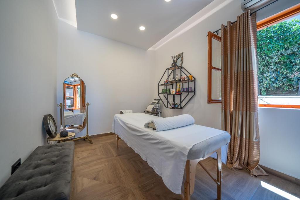 a bedroom with a bed and a mirror and a window at Apartments Nikčević in Kotor