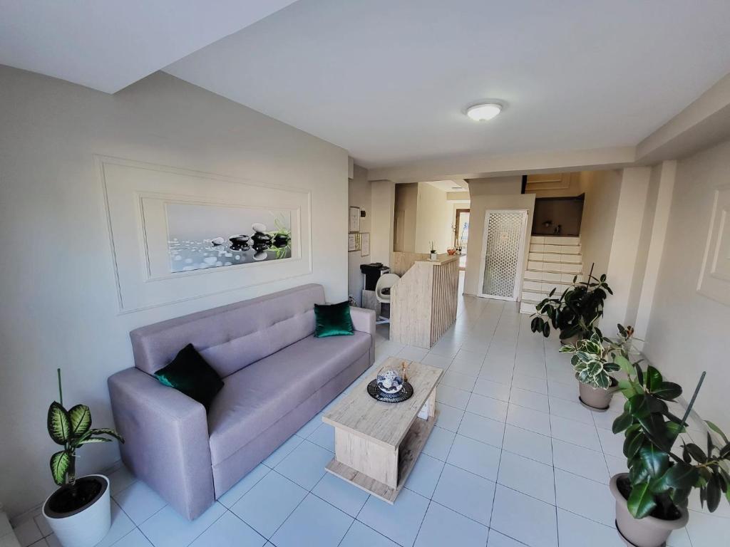 a living room with a couch and a table at Casa Sagrada in Eforie Nord