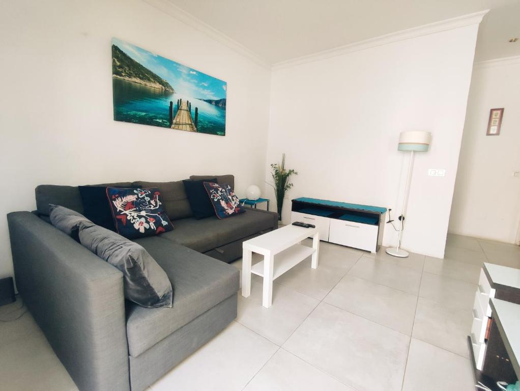 a living room with a couch and a table at CENTER & WHITE TOWN Apartament in Torremolinos