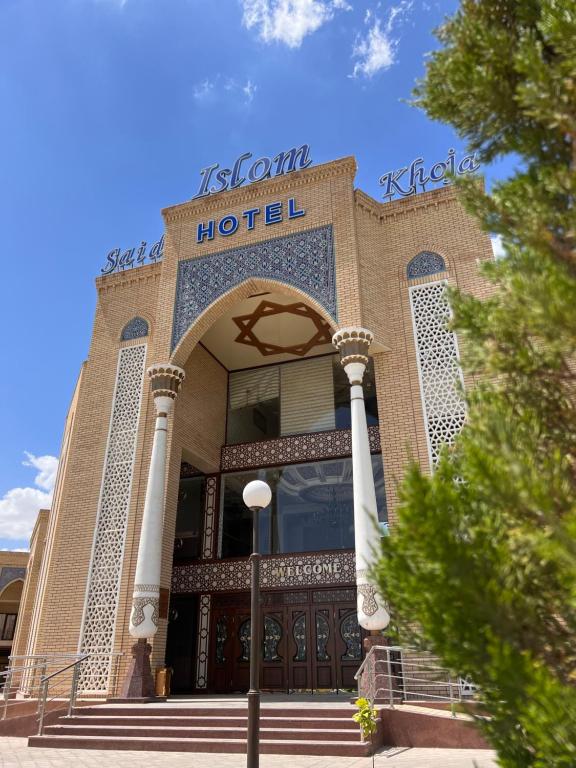 a hotel building with a sign on top of it at Said Islom Khoja in Khiva