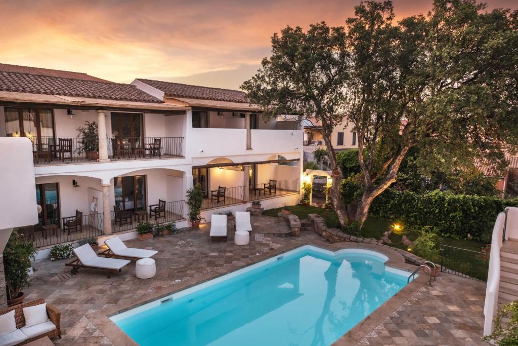 a pool in the backyard of a house at Borgo Antico San Pantaleo in San Pantaleo