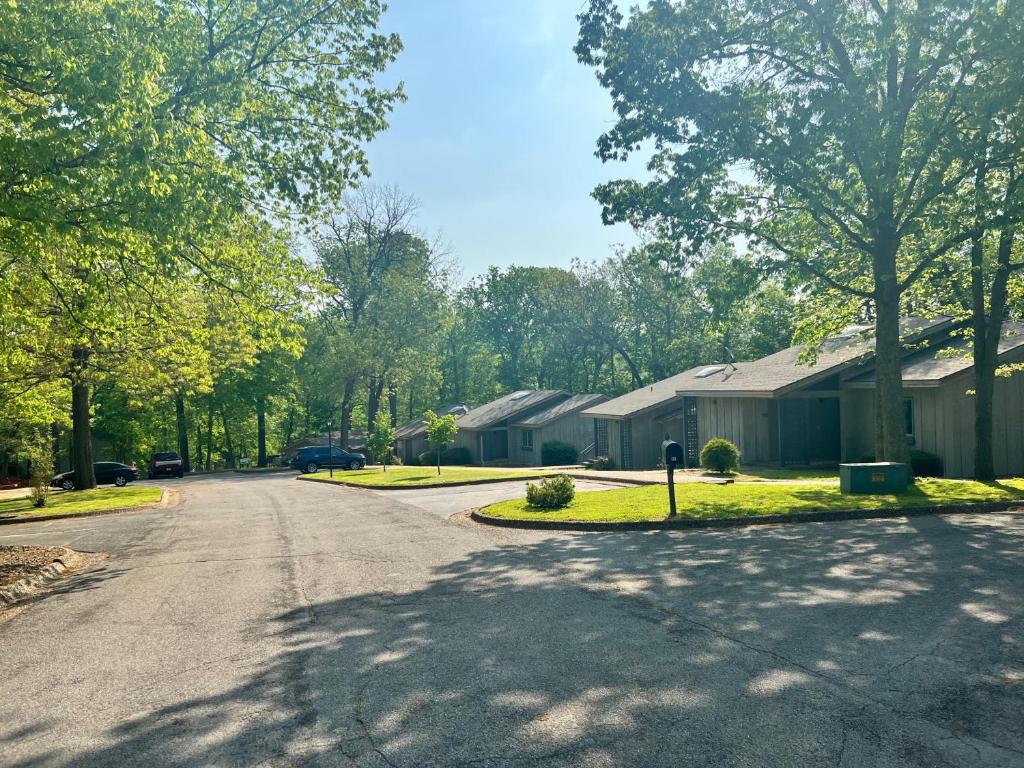 an empty street in a residential neighborhood with houses at Golfside Vacation Home 3 in Bella Vista