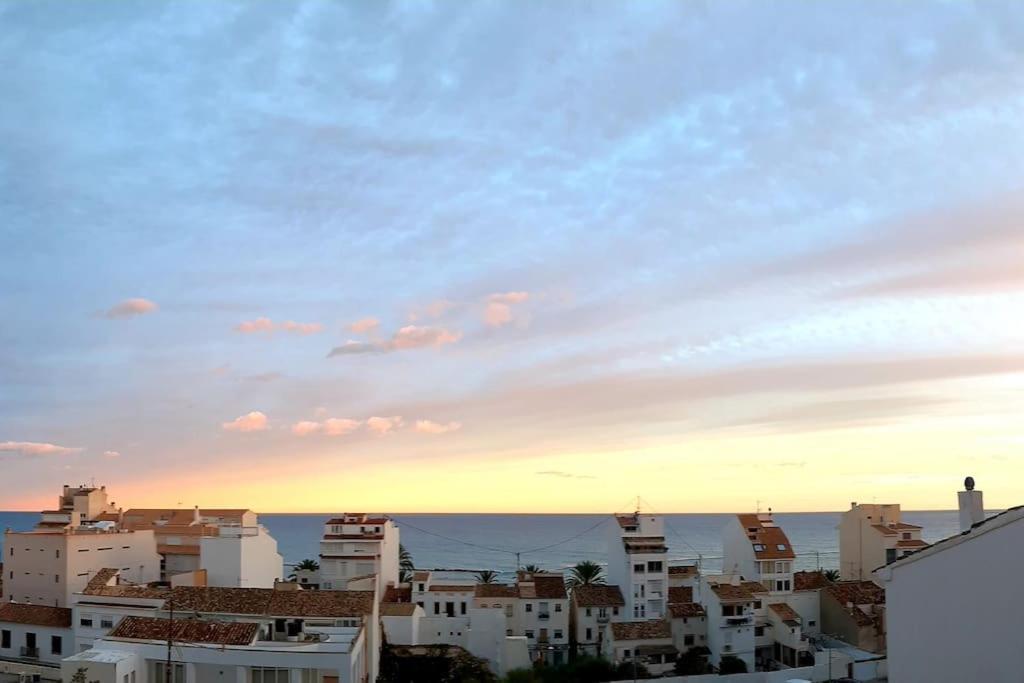 a view of a city at sunset with buildings at Casa Ilusión Altea in Altea