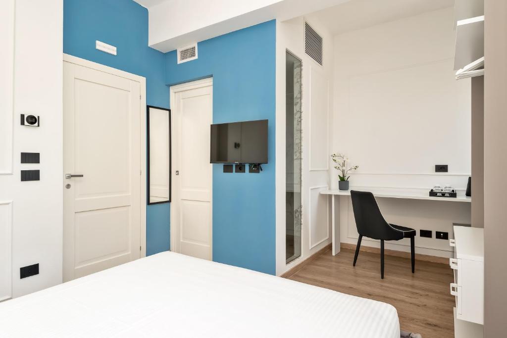 Televízia a/alebo spoločenská miestnosť v ubytovaní Nelli Rooms Via Veneto