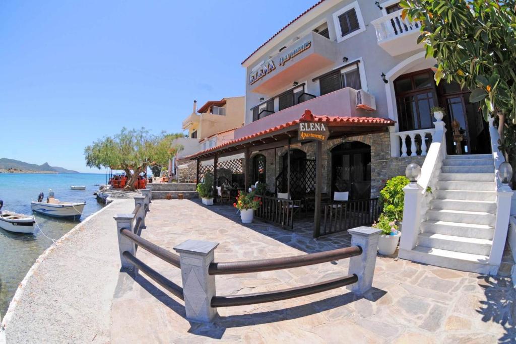 un edificio con un restaurante junto al agua en Elena Apartments, en Psilí Ámmos