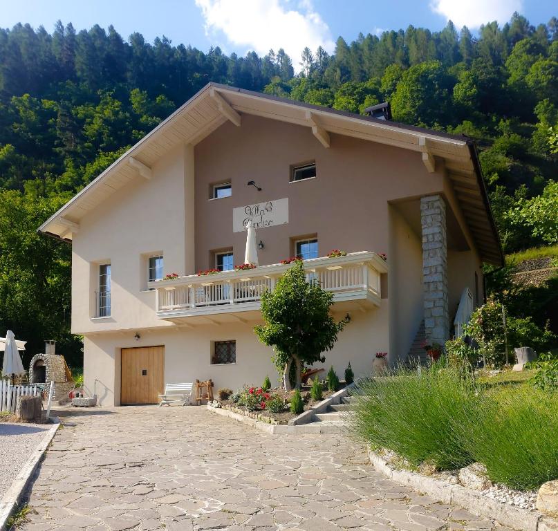 a house with a balcony on the side of it at B&b Villa Paradiso in Mezzana