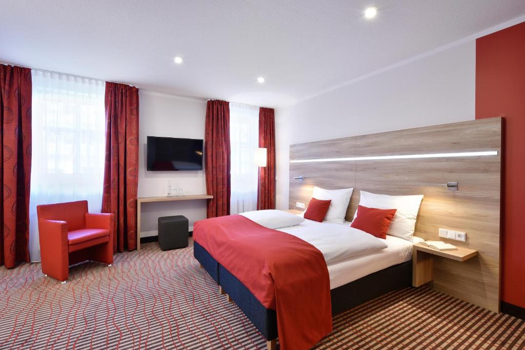 Postel nebo postele na pokoji v ubytování das seidl - Hotel & Tagung - München West