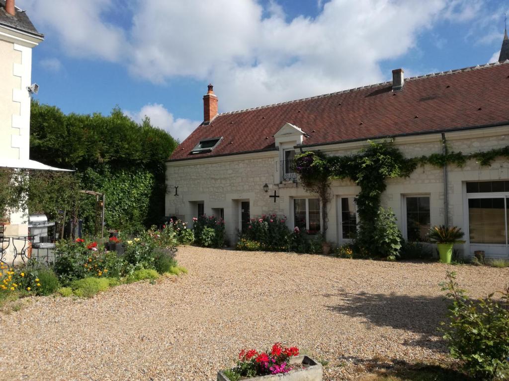 a house with a gravel driveway in front of it at Atypiques Confitures, Chambres d'Hôtes in Couffy