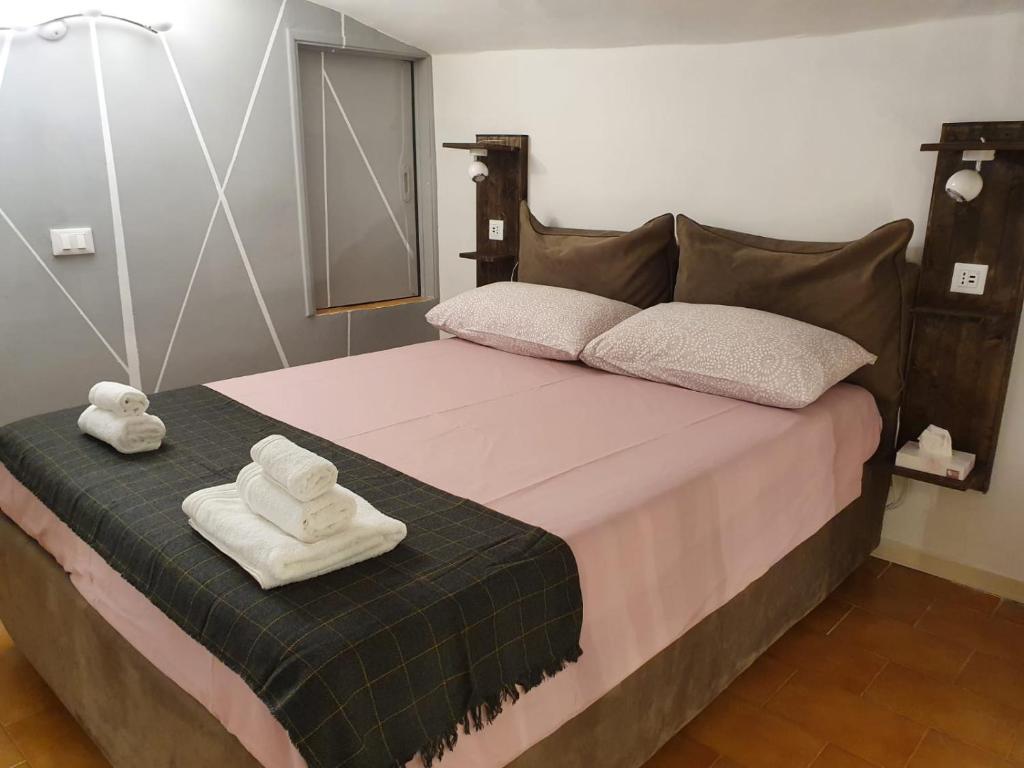 a bedroom with a bed with two towels on it at CASA DI MAGGIE in Sanremo