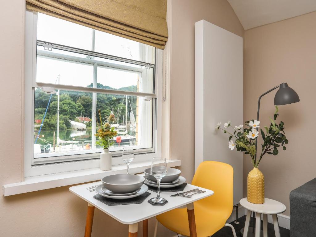 a dining room with a table and a window at Cwm Gwyrfai in Caernarfon