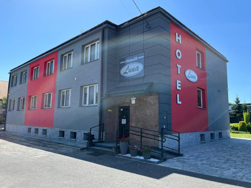 a large building with red and gray at Hotelik Luna in Jarosław