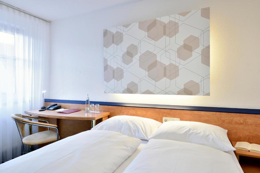 Postel nebo postele na pokoji v ubytování das seidl - Hotel & Tagung - München West