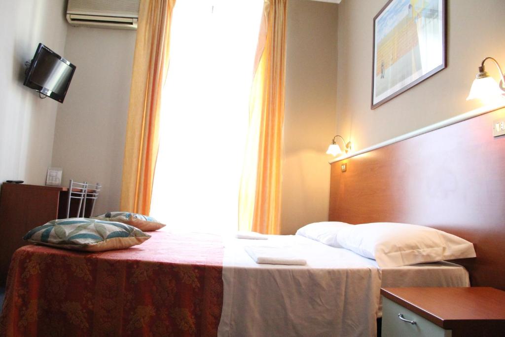 Postel nebo postele na pokoji v ubytování Hotel MM Dateo