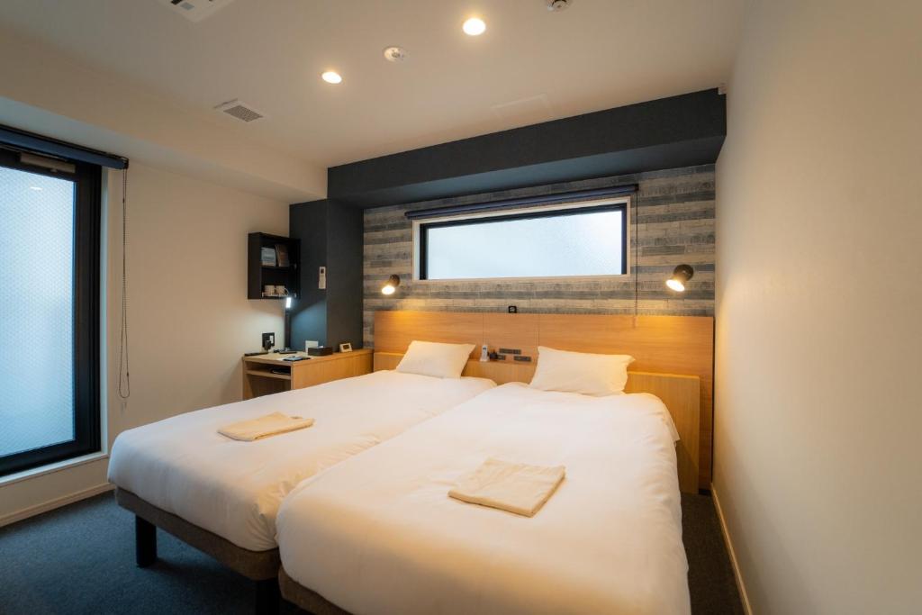 a bedroom with a large bed with two towels on it at HOTEL TABARD TOKYO - Vacation STAY 64558v in Tokyo