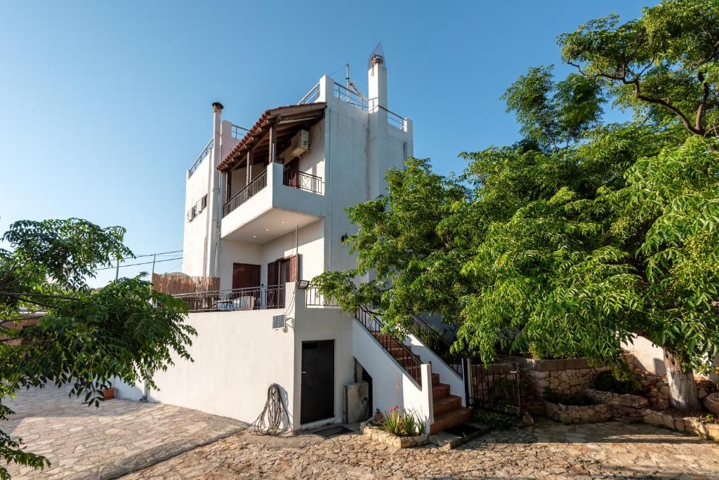 a white house with trees in front of it at ApteraMare Tradidtional house 'New listing 2022' in Chania Town
