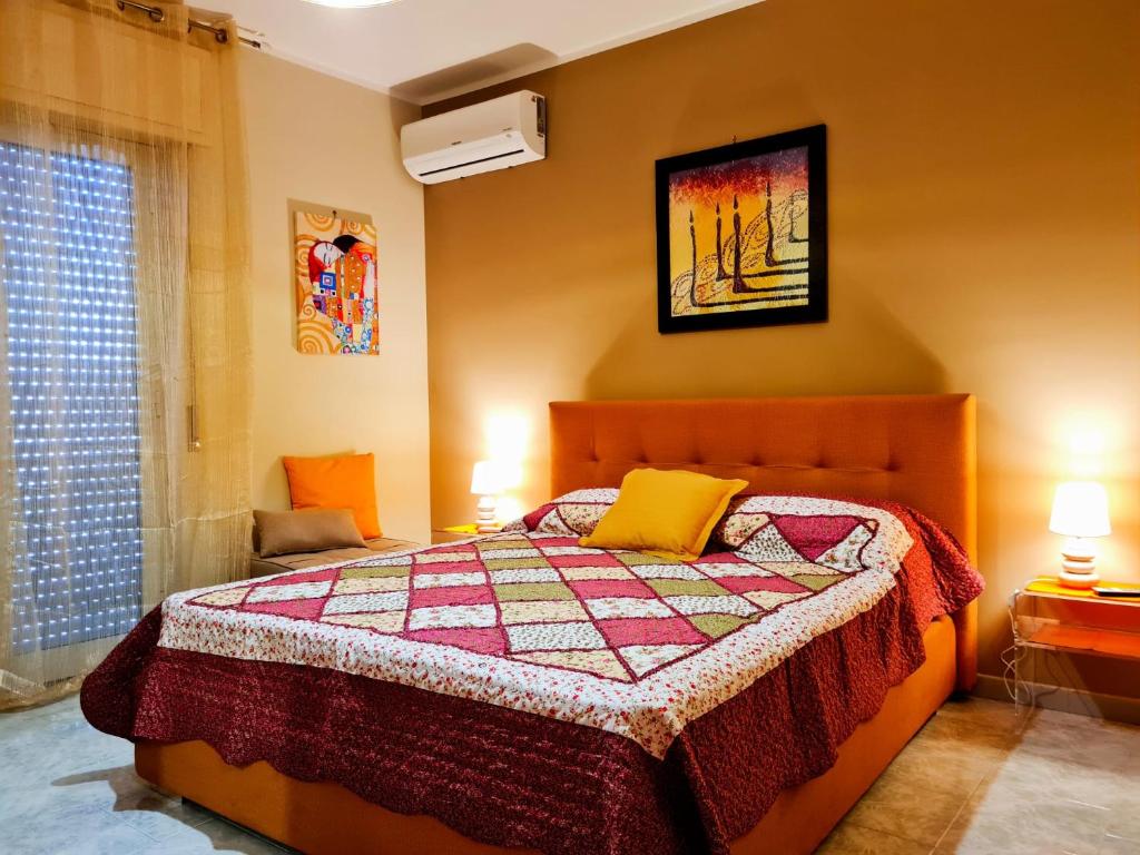 a bedroom with a bed with a quilt on it at Casa Vacanze La Melagrana in Modica