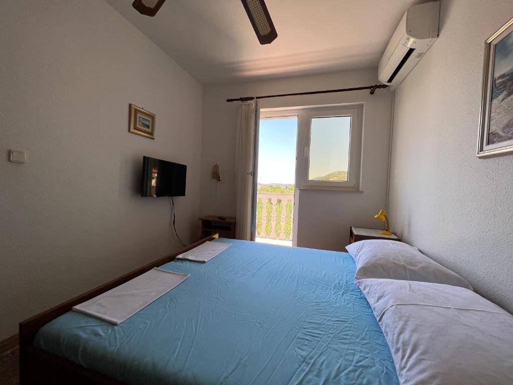 Postel nebo postele na pokoji v ubytování Apartments Vuksan