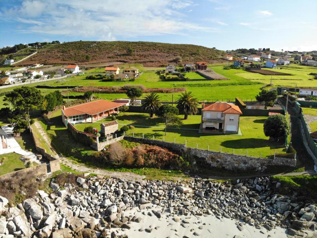 an aerial view of a house on the beach at Villa Roxemar en Costa da Morte in A Coruña