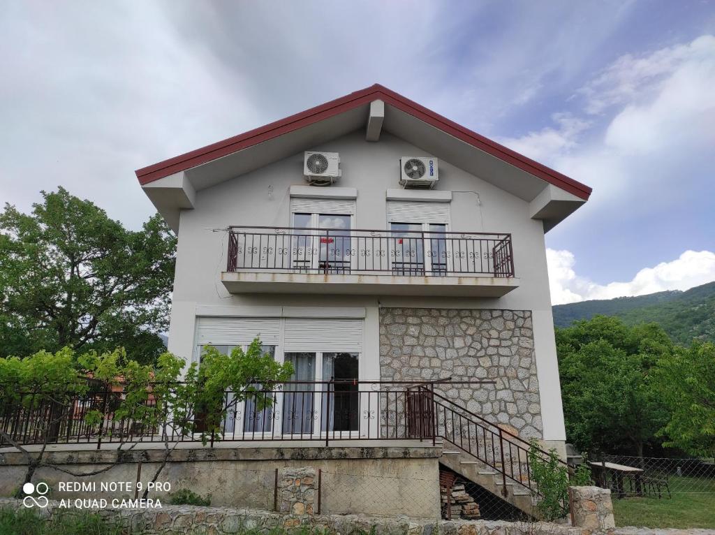 a white house with a balcony and two air conditioners at Aleks in Ohrid