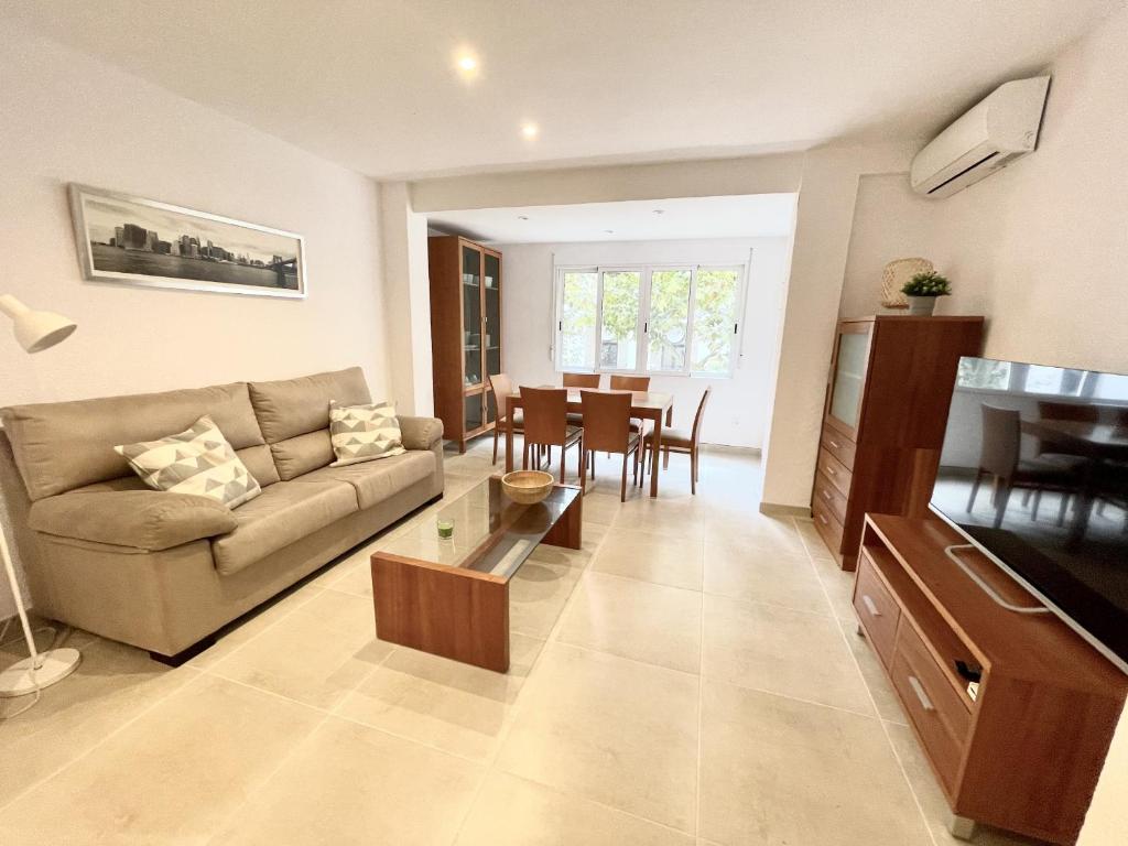 a living room with a couch and a table at Piso en el Puerto de Dénia con balcón in Denia