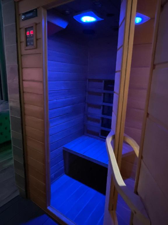 a sauna with blue lights in a room at Fullmoon By Cloud in Aubervilliers