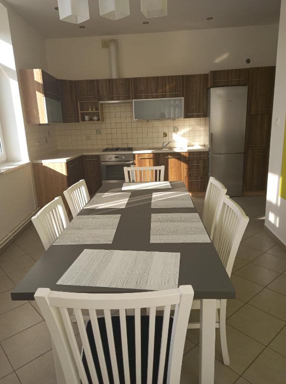 a kitchen with a black and white table and chairs at Apartament ZOSIA in Korczyna