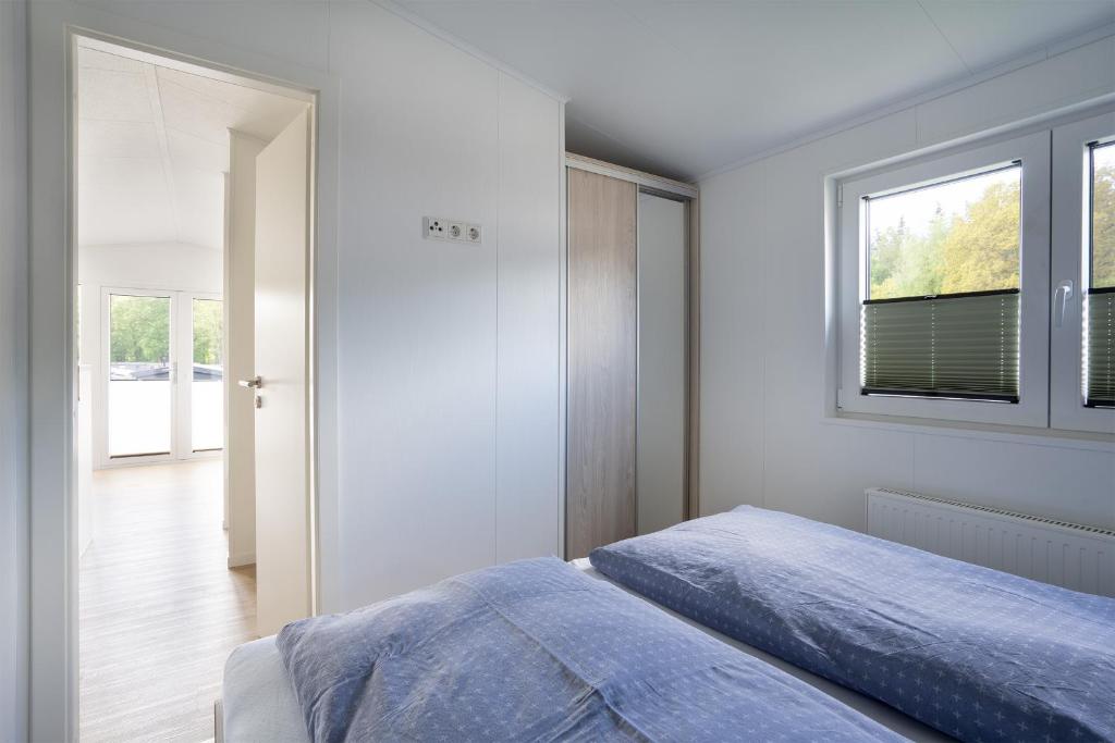 Postel nebo postele na pokoji v ubytování Ferienhaus "TO HUUS" mit kostenfreier Saunanutzung