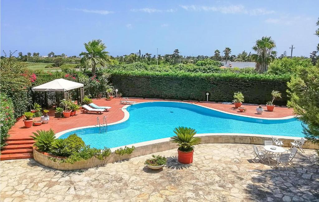 - une grande piscine dans une cour ornée de plantes dans l'établissement Gorgeous Apartment In Frigole With Kitchen, à Frigole