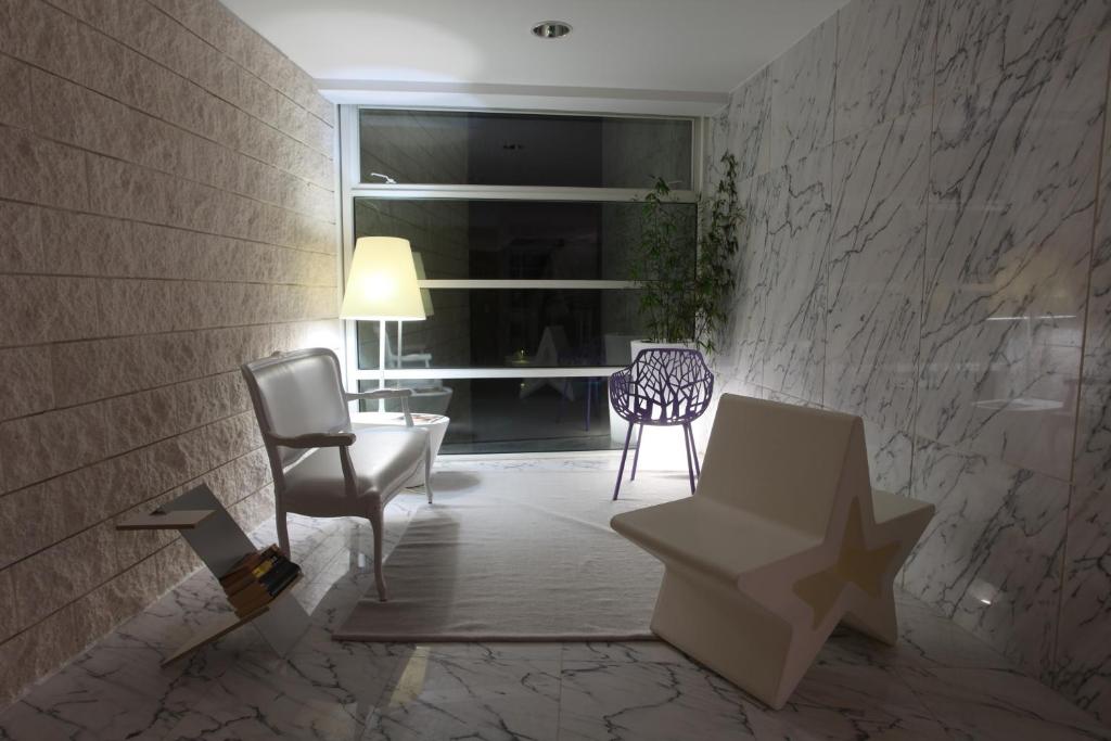 a living room with chairs and a table and a window at Marina Club Lagos Resort in Lagos