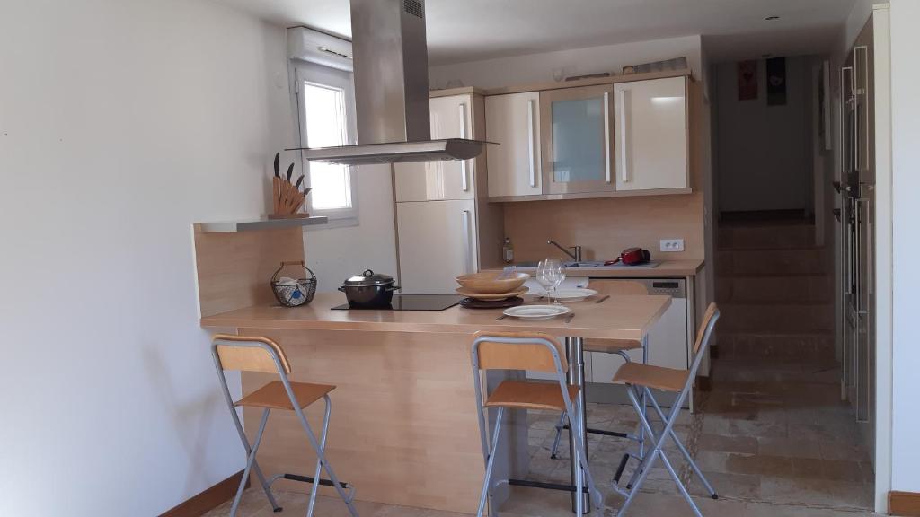 a kitchen with a table and chairs in a room at l appart in Dourdan