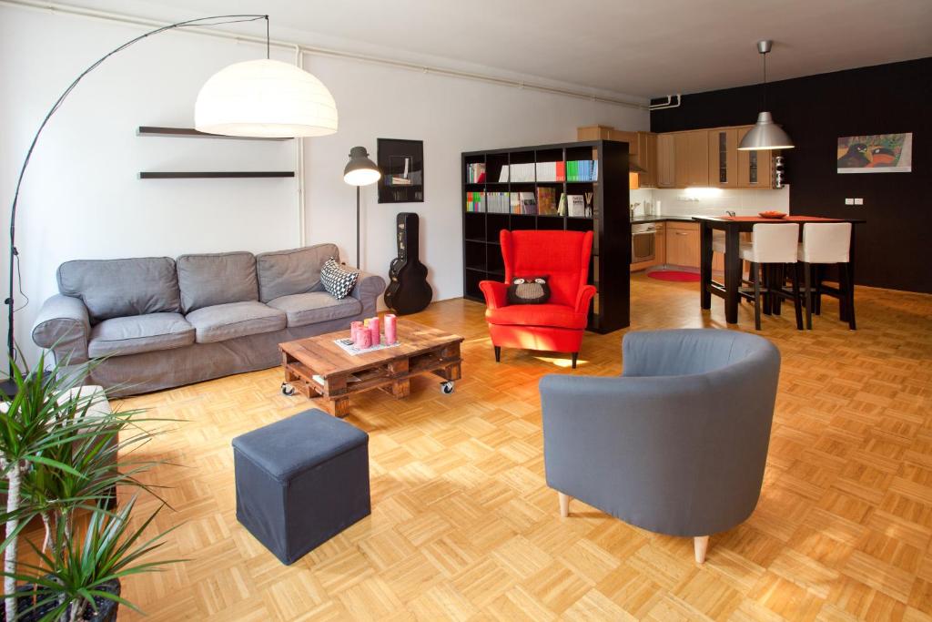 a living room with a couch and chairs and a table at Apartment REZIDENCA GOGA in Novo Mesto