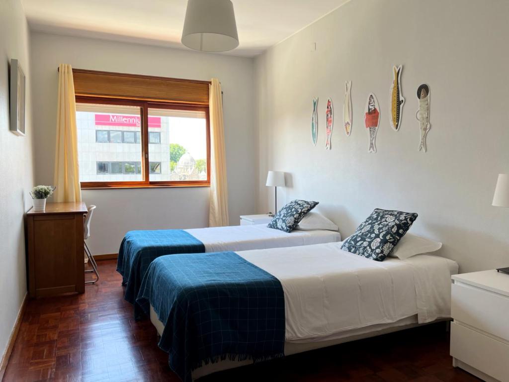 a hotel room with two beds and a window at Boavista YourHome in Porto