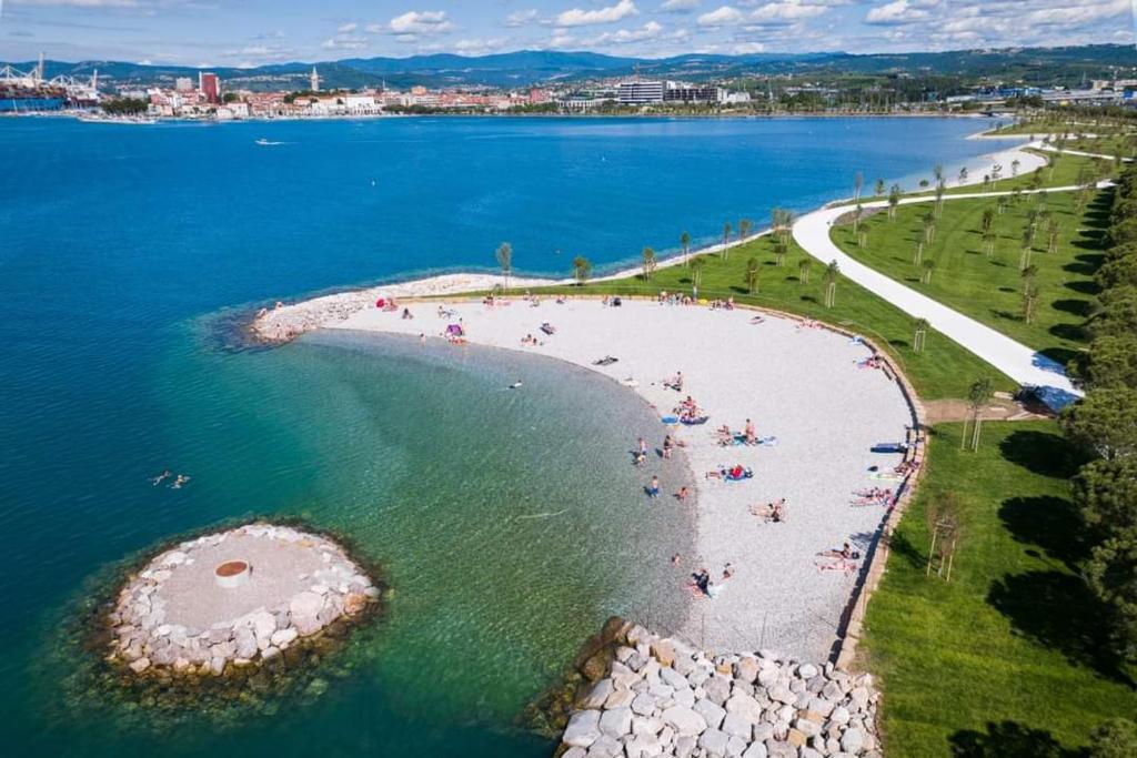 an aerial view of a beach with people in the water at Apartment Retro III in Koper