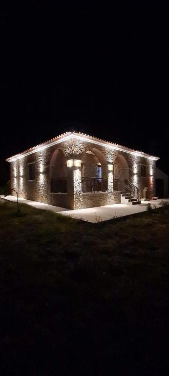a brick building with lights on it at night at VILLA PORTIANOU in Pedhinón