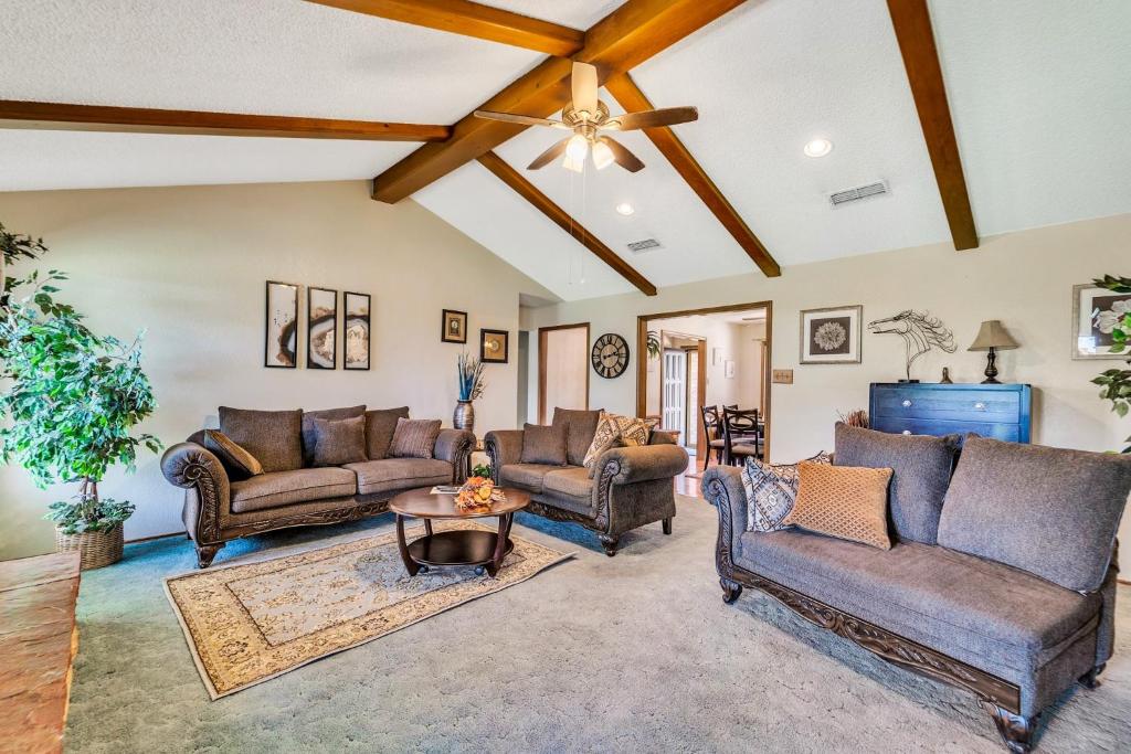 a living room with couches and a table at Homestead House - In Shadow Hills Golf Course Division Home in Lubbock