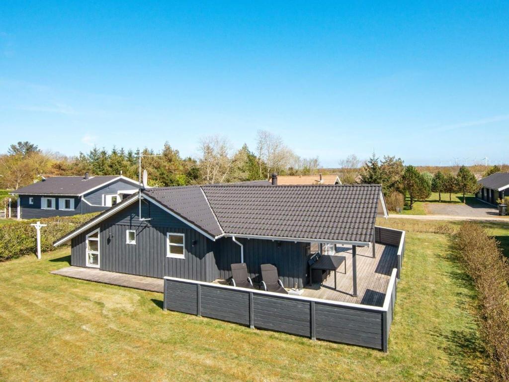 a house with a large deck in the backyard at 6 person holiday home in Hemmet in Hemmet