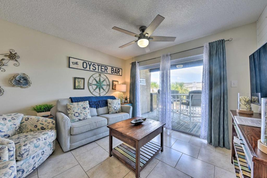 a living room with a couch and a table at Ocean-View Resort Condo with Pool and Beach Access in Fernandina Beach