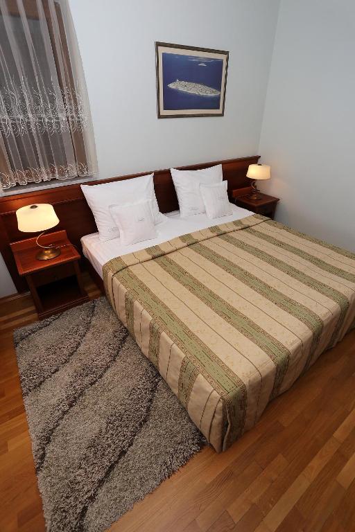 Łóżko lub łóżka w pokoju w obiekcie Villa Ivana B&B